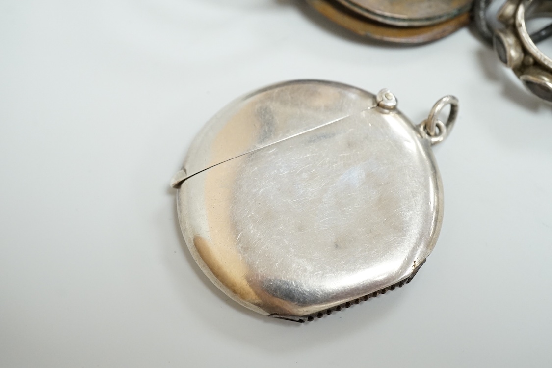 A George V silver circular vesta case, S. Blanckensee & Son Ltd, Birmingham, 43mm, together with a damaged silver child's rattle by George Unite, a cat child's rattle, white metal and lapis lazuli set fob, etc.